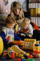 A woman playing with children; Actual Size=130 pixels wide